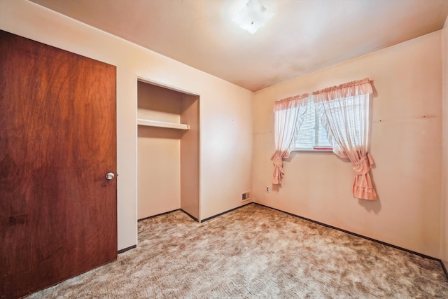 unfurnished bedroom with baseboards, carpet flooring, and visible vents