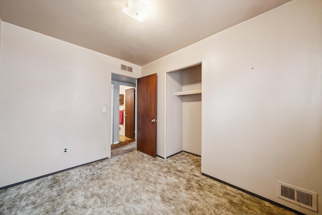 unfurnished bedroom with baseboards, visible vents, and carpet
