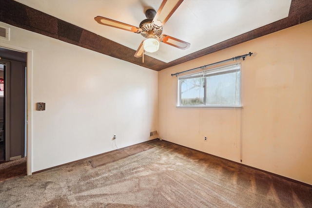 unfurnished room featuring visible vents, a ceiling fan, and carpet