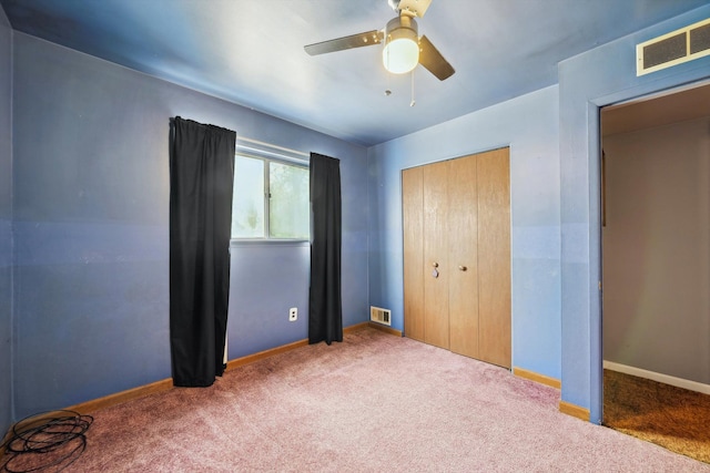 unfurnished bedroom featuring baseboards, visible vents, carpet, and a closet