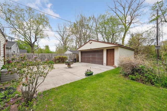 exterior space with fence, an outdoor structure, central AC unit, and a garage