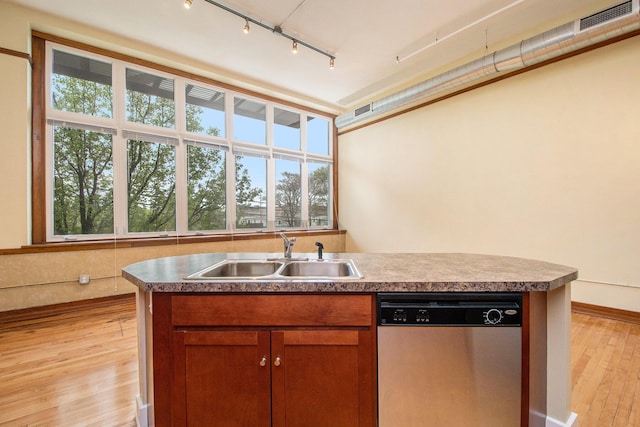 kitchen featuring stainless steel dishwasher, visible vents, light wood-type flooring, rail lighting, and a sink