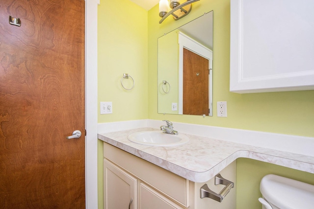 bathroom featuring toilet and vanity