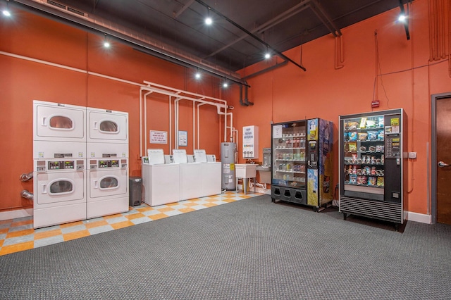 interior space featuring visible vents, washer and clothes dryer, stacked washer / dryer, and water heater