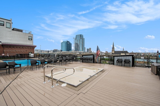 deck with fence and a city view