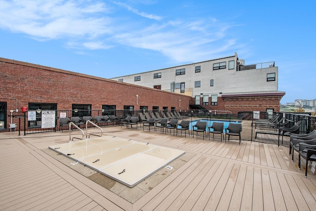 wooden terrace featuring fence
