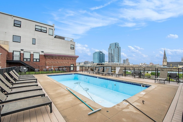 pool with fence and a city view