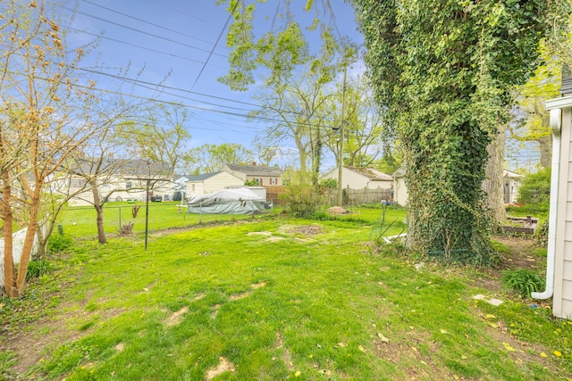 view of yard featuring fence and a residential view