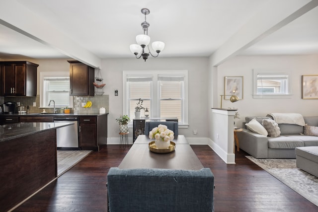 interior space with an inviting chandelier, plenty of natural light, stainless steel dishwasher, and dark brown cabinetry