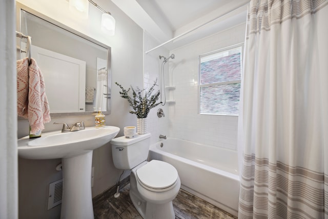 full bathroom featuring toilet, shower / bathtub combination with curtain, and wood finished floors
