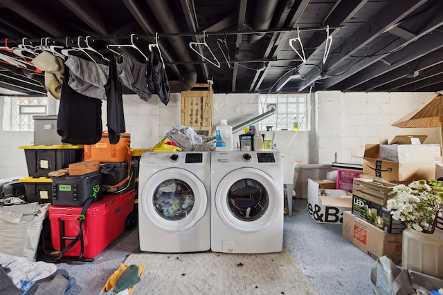 clothes washing area featuring laundry area and washing machine and dryer