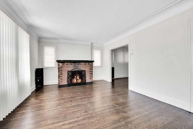 16560 Ashton Ave, Detroit, MI 48219 - unfurnished living room featuring a brick fireplace, a textured ceiling, dark wood-style flooring, baseboards, and crown molding