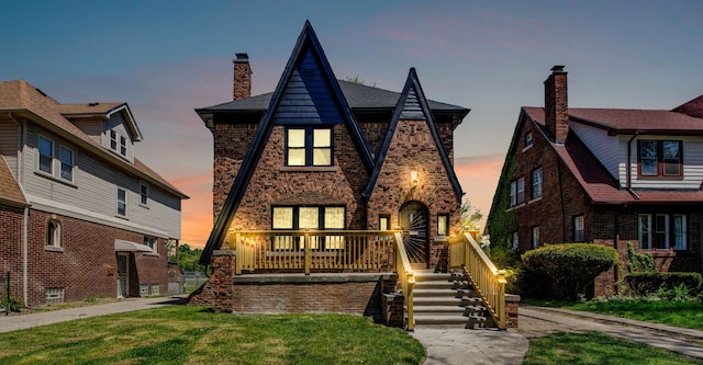 16560 Ashton Ave, Detroit, MI 48219 - english style home featuring a chimney, a lawn, and brick siding