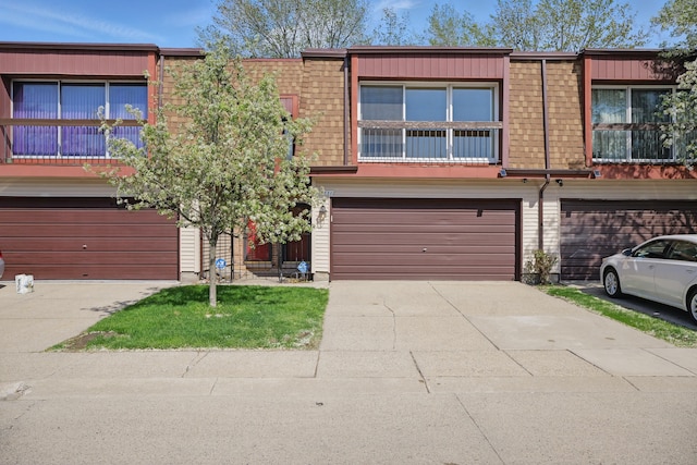 25030 Sherwood Cir, Southfield, MI 48075 - multi unit property with a garage, concrete driveway, and mansard roof