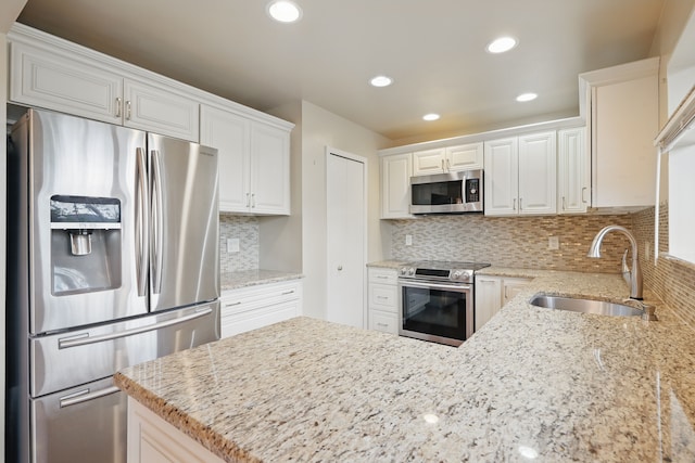 25030 Sherwood Cir, Southfield, MI 48075 - kitchen with backsplash, stainless steel appliances, light stone counters, and a sink