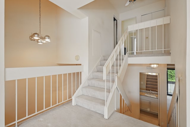 25030 Sherwood Cir, Southfield, MI 48075 - stairway with a towering ceiling, carpet flooring, and a notable chandelier