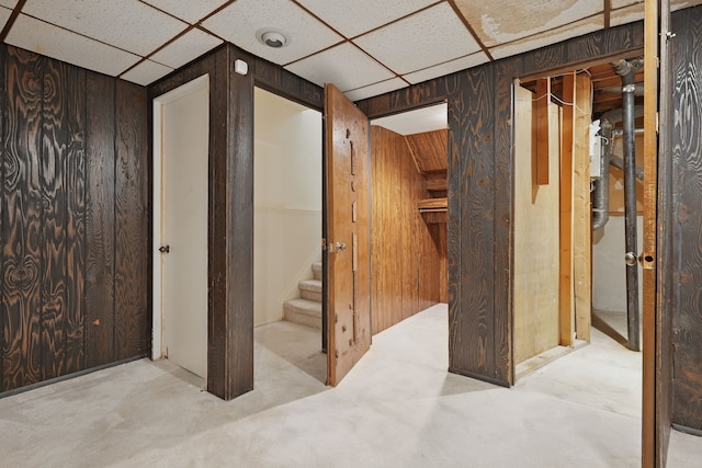 25030 Sherwood Cir, Southfield, MI 48075 - basement featuring stairs, a drop ceiling, and wooden walls