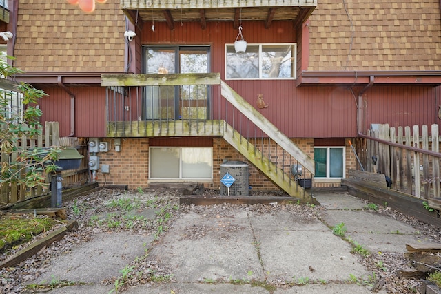 25030 Sherwood Cir, Southfield, MI 48075 - rear view of property with roof with shingles, stairs, mansard roof, and brick siding