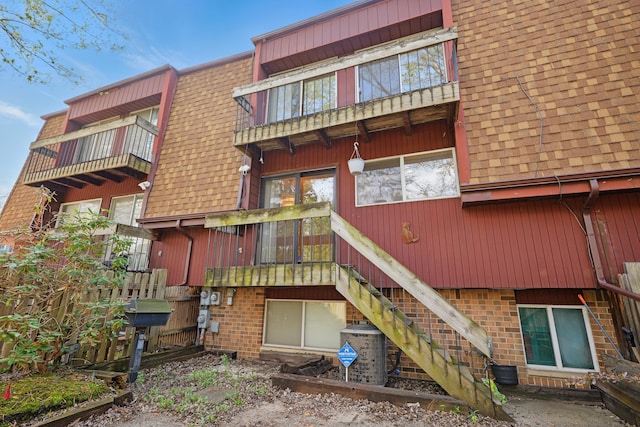 25030 Sherwood Cir, Southfield, MI 48075 - rear view of property with roof with shingles, brick siding, stairway, and a balcony