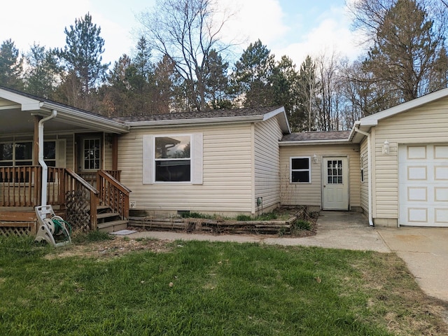 view of front of house featuring a garage, a shingled roof, driveway, and a front yard