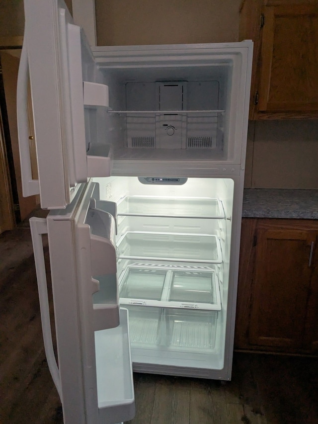 interior details with brown cabinets and refrigerator