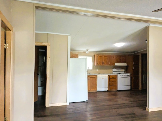 kitchen with dark wood finished floors, beam ceiling, light countertops, under cabinet range hood, and white appliances