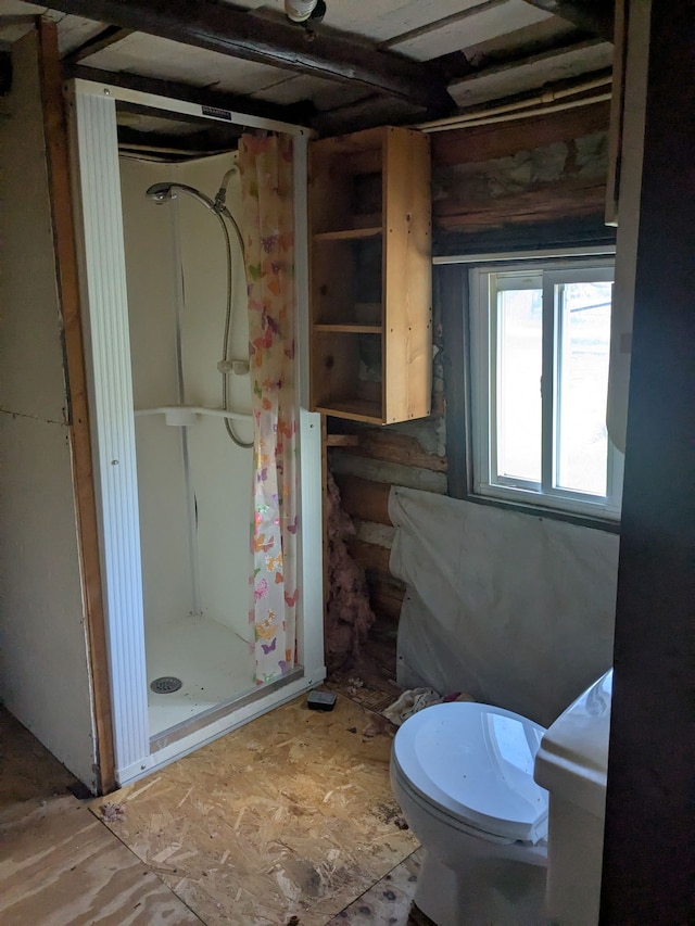 bathroom with a stall shower and toilet