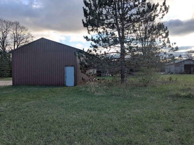 view of pole building with a lawn
