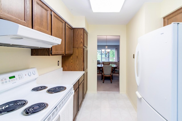 kitchen featuring brown cabinets, an inviting chandelier, white appliances, light countertops, and under cabinet range hood