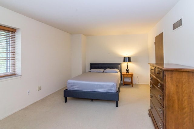 bedroom with light colored carpet and visible vents