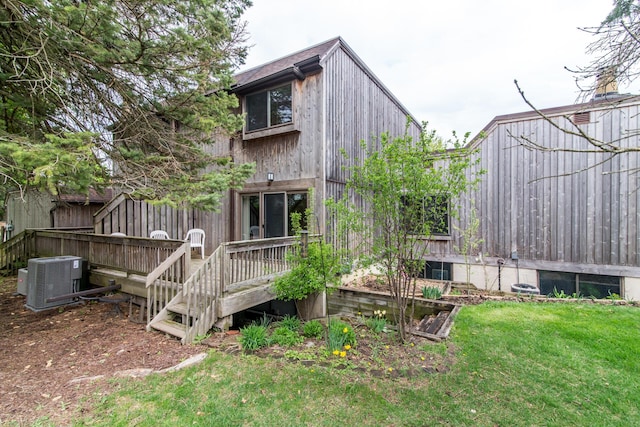 back of house featuring central air condition unit, a yard, and a deck