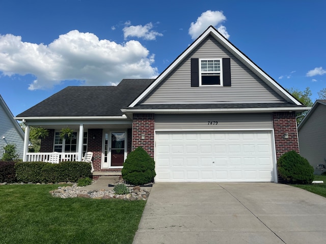 traditional home with brick siding, concrete driveway, covered porch, and a garage