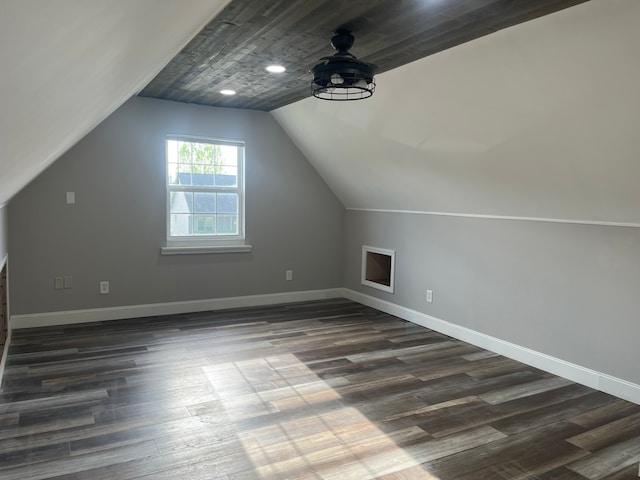 bonus room with dark wood-style floors, vaulted ceiling, baseboards, and a ceiling fan