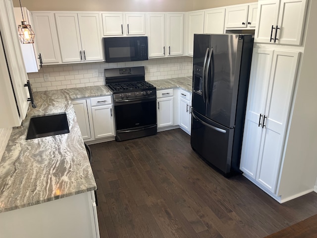 kitchen featuring black appliances, dark wood finished floors, and white cabinets