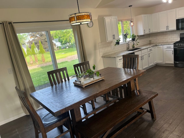 dining room with dark wood finished floors and baseboards