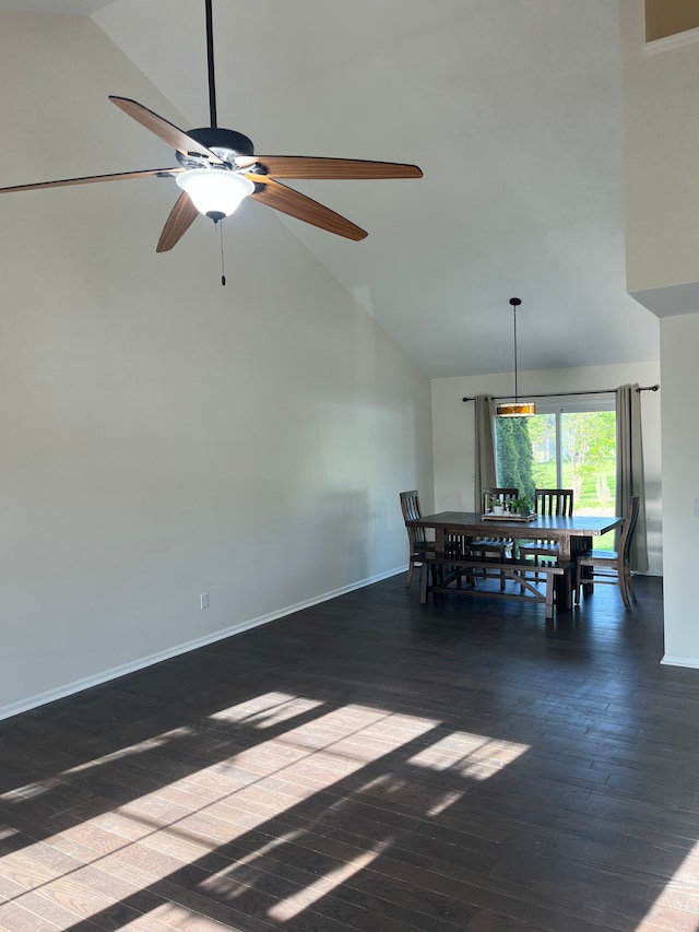 dining room with high vaulted ceiling, a ceiling fan, wood finished floors, and baseboards