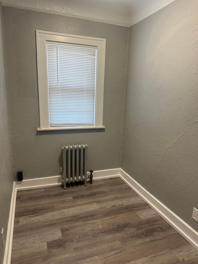 20 Thorpe St, Pontiac, MI 48341 - unfurnished room featuring radiator heating unit, dark wood-type flooring, and baseboards
