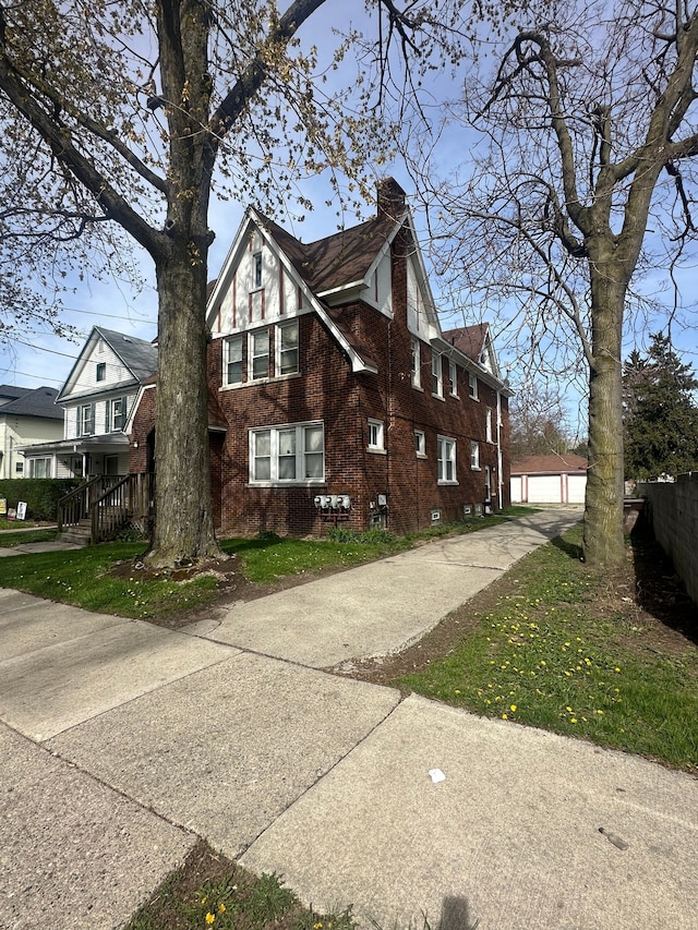 20 Thorpe St, Pontiac, MI 48341 - view of property exterior with a chimney, an outbuilding, and brick siding