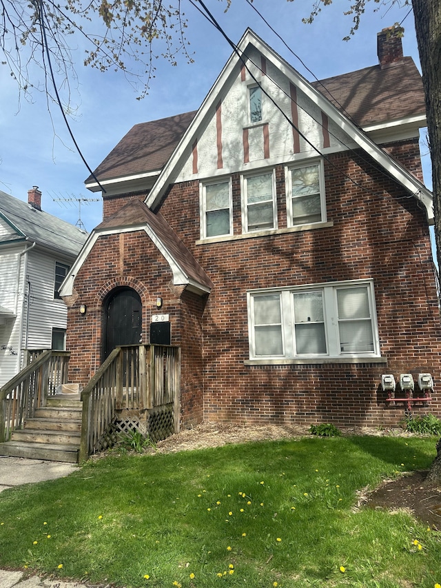 20 Thorpe St, Pontiac, MI 48341 - english style home with a chimney, a front yard, and brick siding