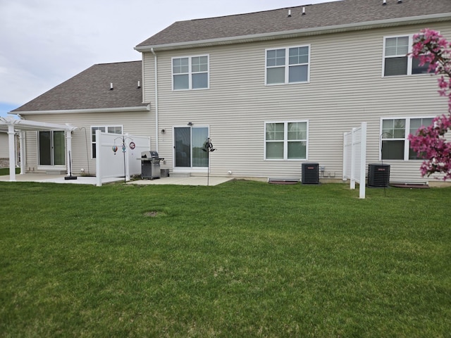 rear view of property with a lawn, a patio, central AC, and a pergola