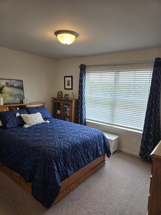 carpeted bedroom featuring baseboards