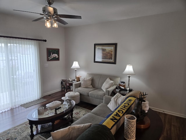 living room with baseboards, ceiling fan, wood finished floors, and visible vents
