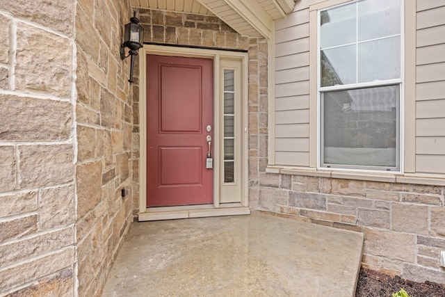 entrance to property featuring stone siding