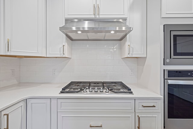 kitchen with backsplash, stainless steel appliances, ventilation hood, and white cabinets