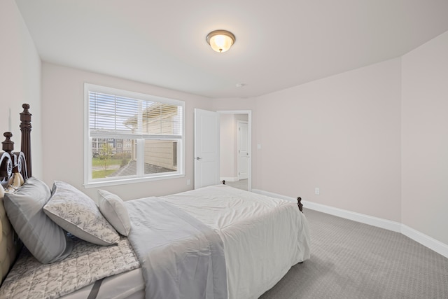 bedroom featuring carpet and baseboards