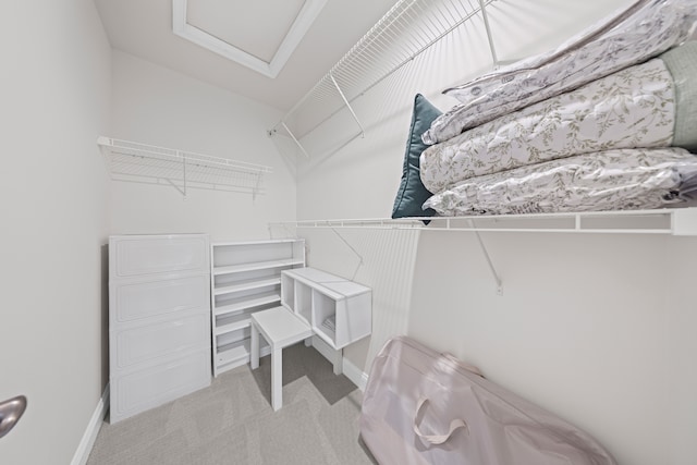spacious closet featuring carpet flooring and attic access