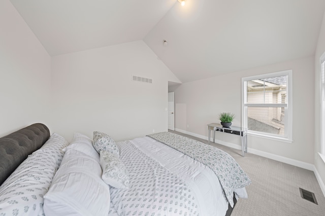 carpeted bedroom with lofted ceiling, baseboards, and visible vents