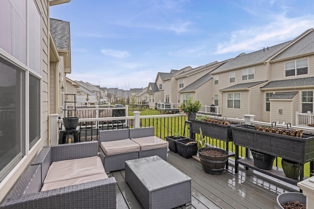 wooden deck featuring a residential view and an outdoor living space