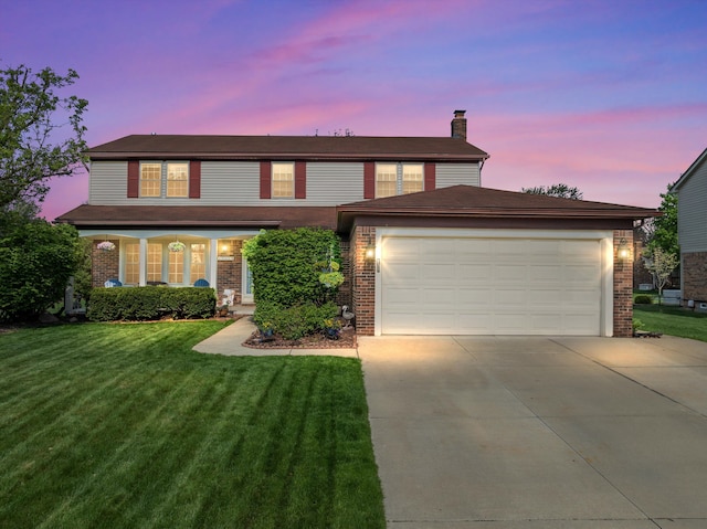 traditional-style home featuring a front lawn, a chimney, brick siding, and driveway