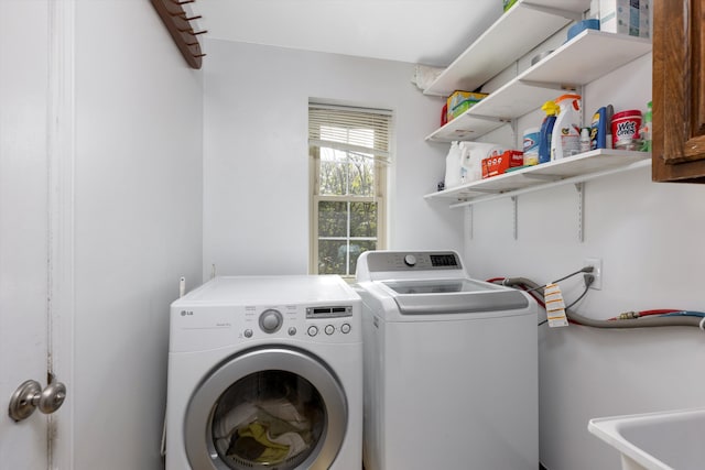 laundry area with a sink, cabinet space, and washer and dryer